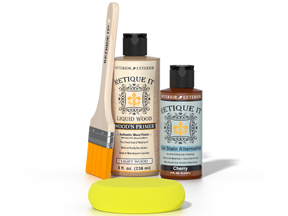 Retique It® Light Wood Wood’n Primer with Cherry Gel Stain Alternative, brush, and yellow sponge on a dark tabletop.