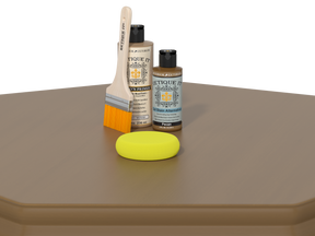 Two bottles, a brush, and a yellow sponge on a brown surface with a white background