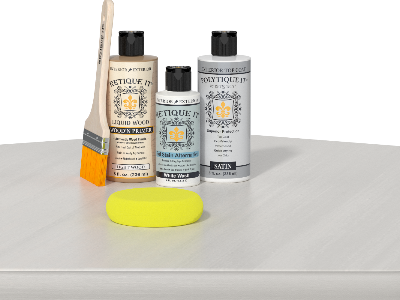 Retique It® Light Wood Wood’n Primer with White Wash Gel Stain Alternative, satin topcoat, brush, and yellow sponge on a white tabletop.