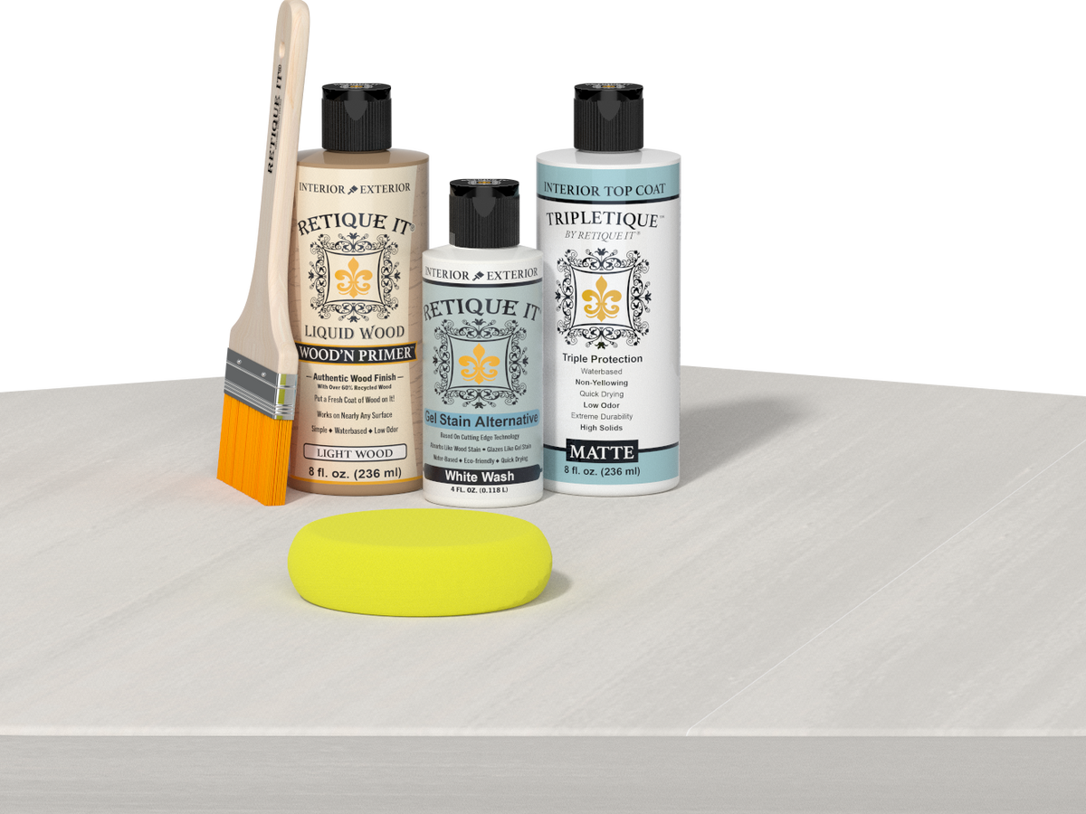 Retique It® Light Wood Wood’n Primer with White Wash Gel Stain Alternative, matte topcoat, and yellow sponge on a white tabletop.