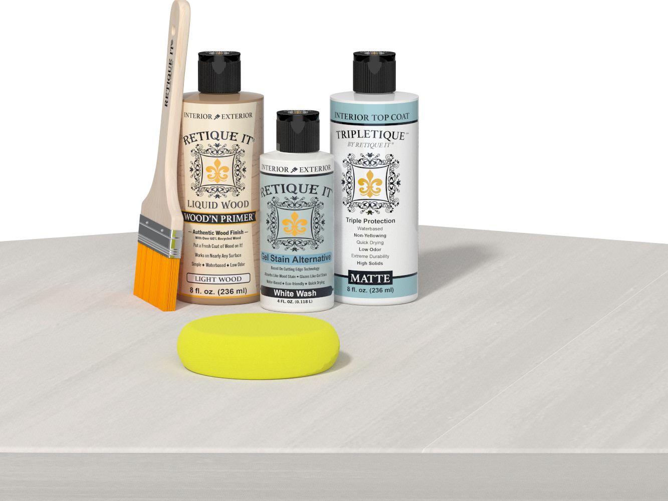 Retique It® Light Wood Wood’n Primer with White Wash Gel Stain Alternative, matte topcoat, and yellow sponge on a white tabletop.