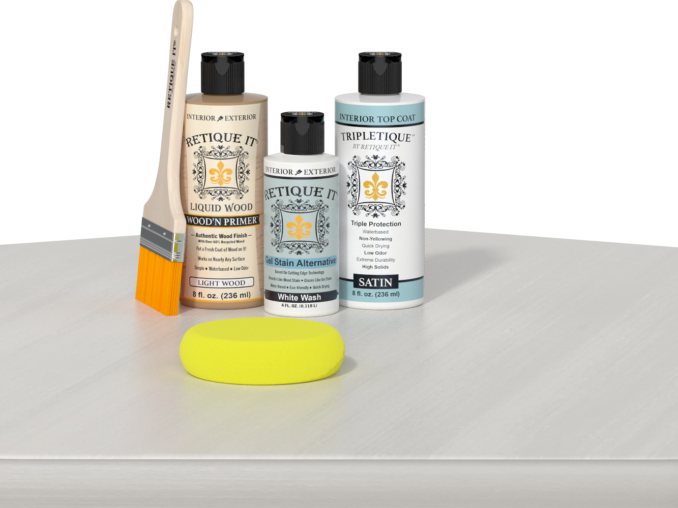 Retique It® Light Wood Wood’n Primer with White Wash Gel Stain Alternative, satin topcoat, brush, and yellow sponge on a white tabletop.