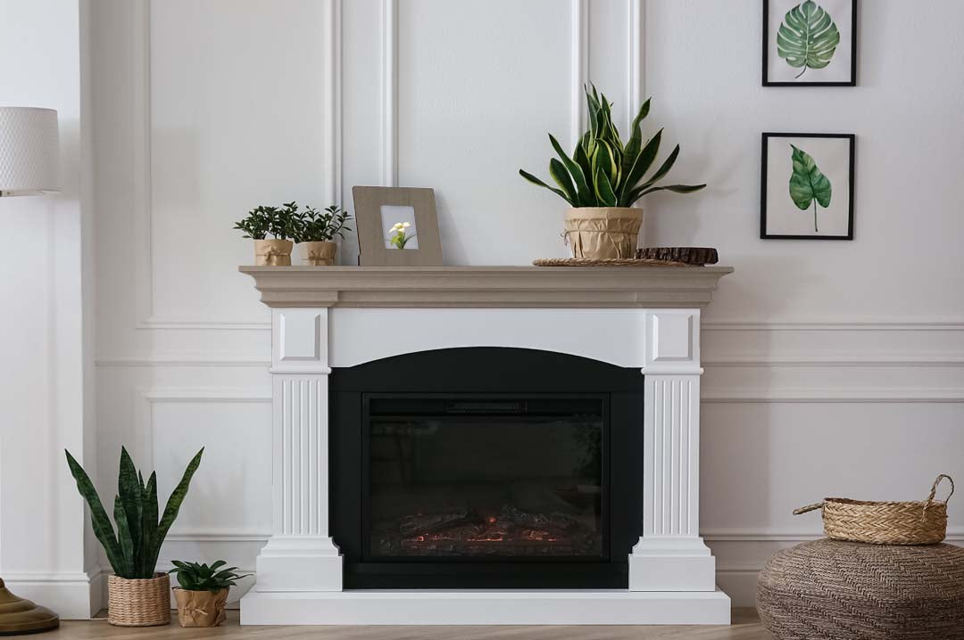 Retique It wood finish kit with four large containers of harbor gray smooth finish, displayed near a fireplace mantle.