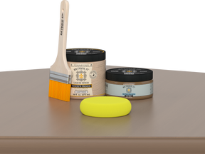 Retique It Barn Wood Kit with Light Wood Wood'n Primer, Barn Wood Gel Stain Alternative, paintbrush, and yellow sponge on a tabletop.