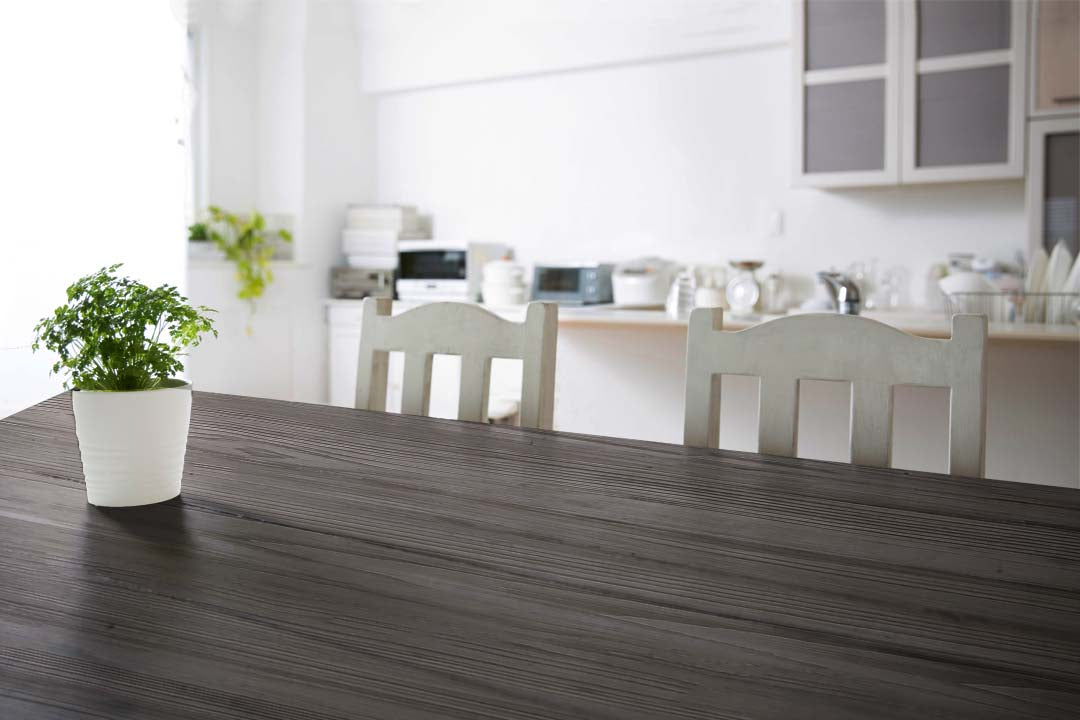 Large Harbor Gray Wood'n Kit interior top coat applied to a grained wooden tabletop, showcasing the wood finish and texture.