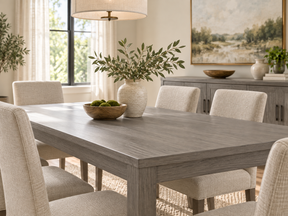 Weathered Gray dining table and matching sideboard with cream upholstered chairs in a bright dining room.