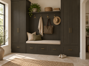 Carbon Gray built-in mudroom cabinets and cushioned storage bench with brass handles and coat hooks.