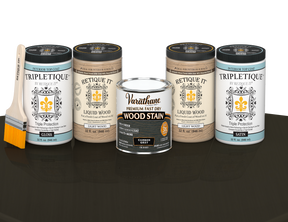 64 oz Retique It Liquid Wood kit with Carbon Gray stain, gloss Tripletique topcoat, and a paintbrush on a matching finished tabletop.