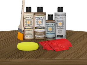 Retique It Wood'n Finish Kit in Barn Wood with exterior topcoat, featuring wood panels and finishing tools on a table surface.