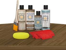 Retique It® Barn Wood Wood'n Kit with Light Wood primer, Barn Wood stain, Barn Wood gel stain alternative, Matte Tripletique® Top Coat, brush, red graining tool, and yellow sponge.