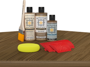 Retique It® Wood'n Finish Kit in Barn Wood on table, showcasing multi-purpose wood finishing kit with rustic wood appearance.