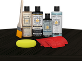 Retique It® Classic Black Wood'n Kit with Light Wood primer, Classic Black stain, Classic Black gel stain alternative, Matte Tripletique® Top Coat, brush, red graining tool, and yellow sponge.