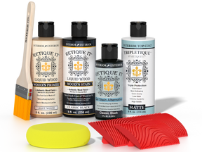 Retique It® Classic Black Wood'n Kit with Light Wood primer, Classic Black stain, Classic Black gel stain alternative, Matte Tripletique® Top Coat, brush, red graining tool, and yellow sponge.