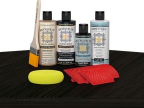 Retique It® Classic Black Wood'n Kit with Light Wood primer, Classic Black stain, Classic Black gel stain alternative, Satin Tripletique® Top Coat, brush, red graining tool, and yellow sponge.