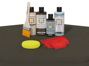 Set of wood care products including bottles, a brush, a sponge, and cloths on a dark surface.