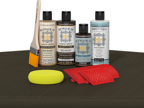 Retique It® Charcoal Wood'n Kit with Light Wood primer, Charcoal stain, Charcoal gel stain alternative, Matte Tripletique® Top Coat, brush, red graining tool, and yellow sponge.