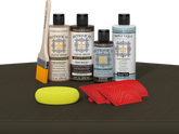 Retique It® Charcoal Wood'n Kit with Light Wood primer, Charcoal stain, Charcoal gel stain alternative, Matte Tripletique® Top Coat, brush, red graining tool, and yellow sponge.