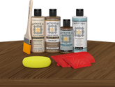 Retique It® Barn Wood Wood'n Kit with Light Wood Primer, Barn Wood Wood'n Stain, Matte TripleTique Top Coat, Pecan Gel Stain Alternative, yellow sponge, red graining tool, and brush.
