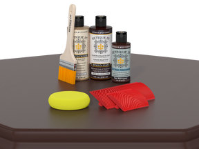 Set of wood care products including bottles, a brush, and sponges on a gray surface.