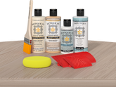 Retique It® Sunbleached Wood'n Kit with Bleached Wood Primer, Pickled Oak Wood'n Stain, Matte TripleTique Top Coat, White Wash Gel Stain Alternative, yellow sponge, red graining tool, and brush.