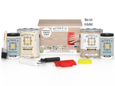 Sun-bleached Retique It Wood'n Finish Kit with four large wood finishing products and a box, ideal for multi-purpose wood projects.