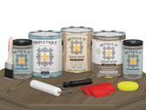 Retique It® Wood'n Finish Kit in Weathered Wood, interior top coat, showing four large matte wood finish containers on a table.
