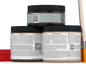 Three jars of wood finish product with labels and a paintbrush on a white background