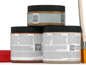 Three jars of wood finish product with labels and a brush on a white background