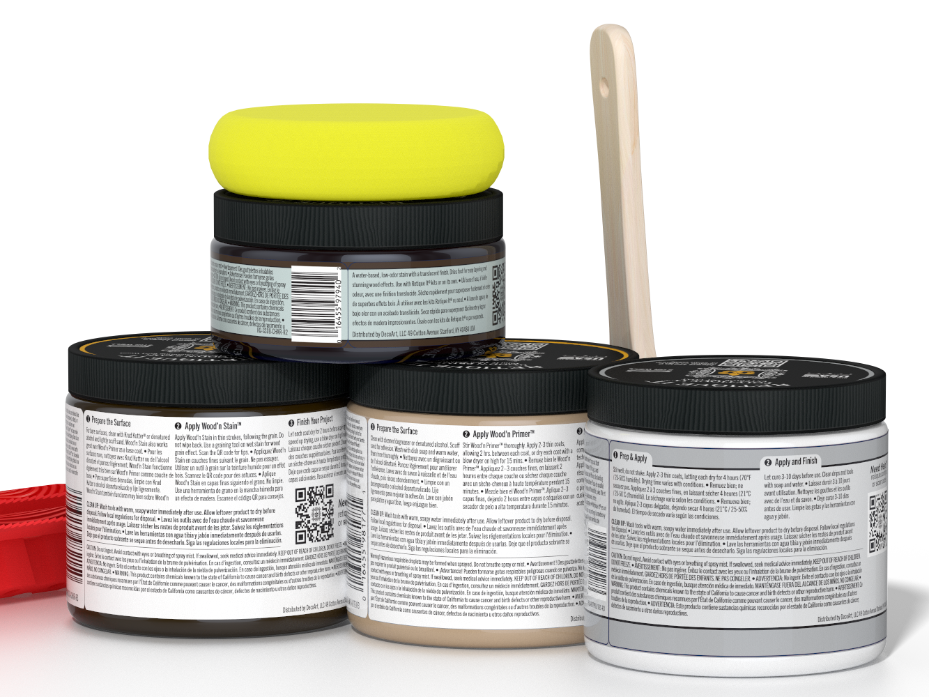 Four jars of paint with a yellow lid and a paintbrush on a white background