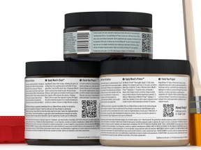 Three jars of wood finish product with labels and a paintbrush on a white background