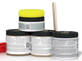 Four jars of a product with a yellow lid on a white background