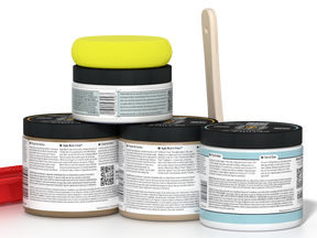 Five jars of paint with a yellow lid on a white background