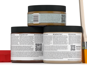 Three jars of wood finish product with labels and a brush on a white background