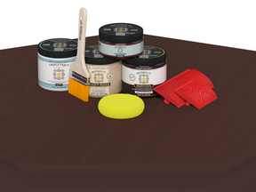 Collection of paint jars, a brush, and a sponge on a brown surface