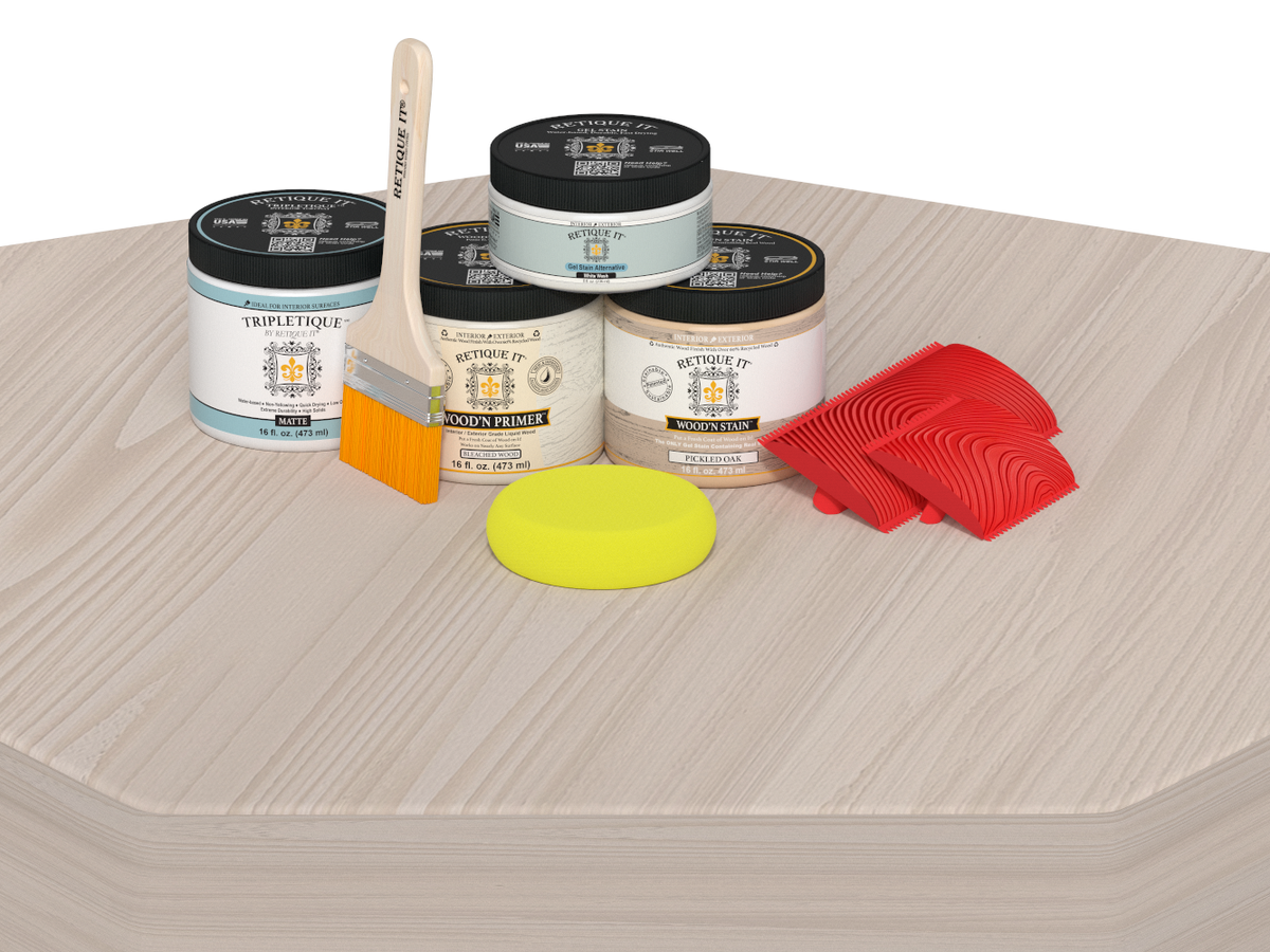 Painting supplies including jars, a brush, and sponges on a textured surface.
