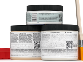 Three jars of wood finish product with labels and a brush on a white background