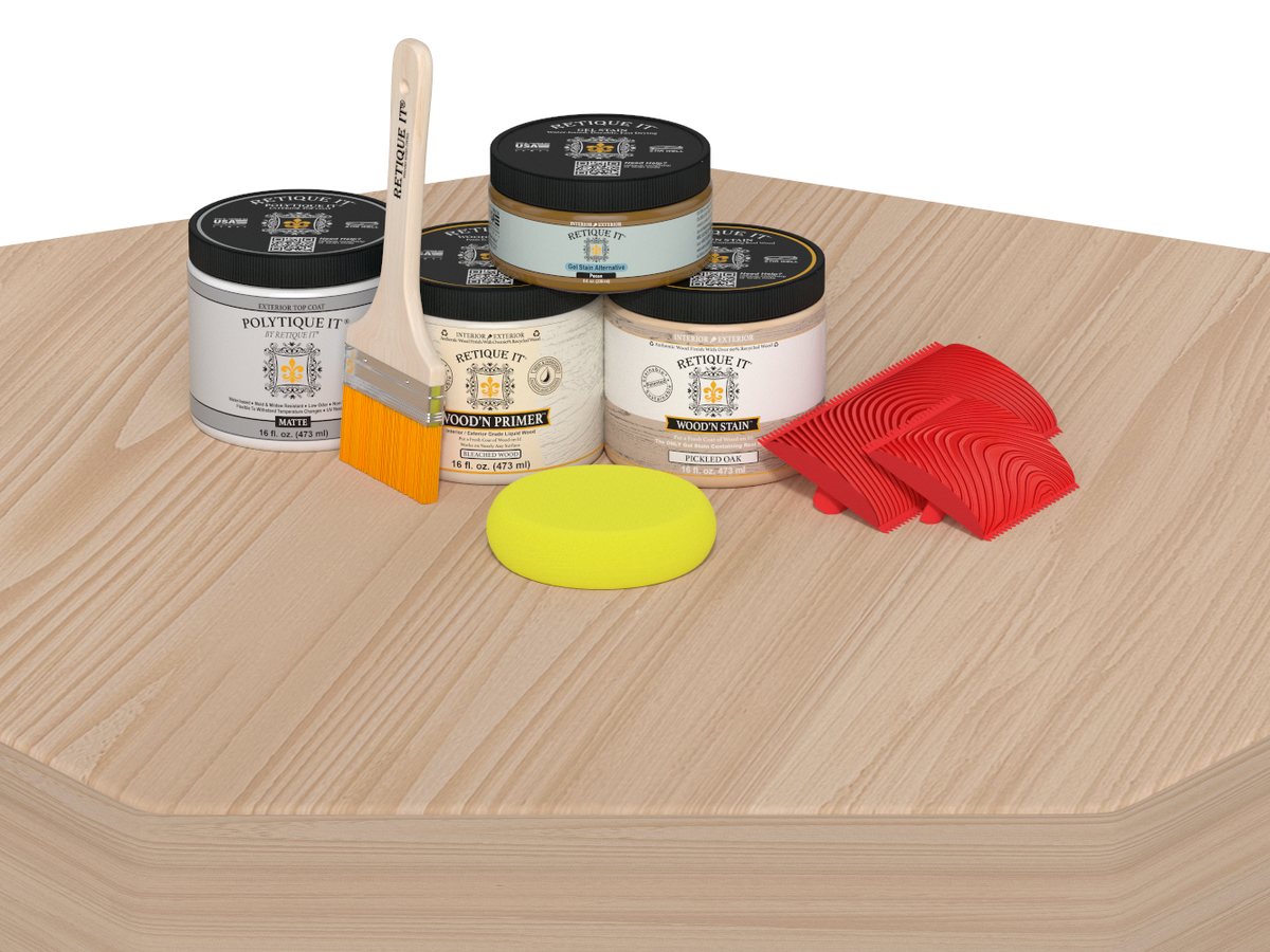Painting supplies including cans, a brush, and sponges on a wooden surface.