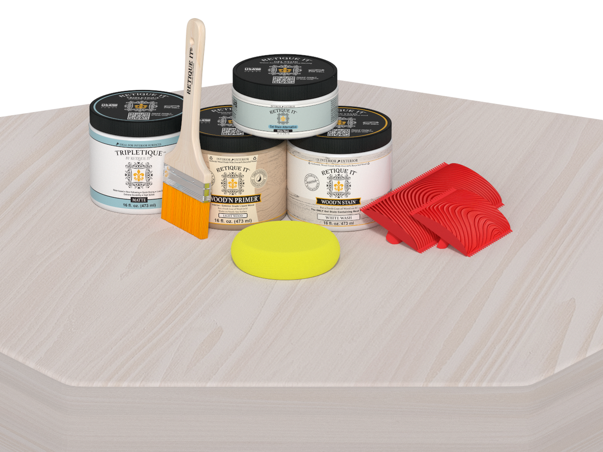 Painting supplies including cans of primer, a brush, a sponge, and sponges on a textured surface.