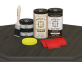 Retique It® Wood'n Cabinet Kit with 12 charcoal-grained door stains displayed on a table, showcasing natural wood finish.