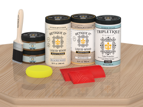 Retique It® Wood'n Finish Kit with four large white oak stain samples on a tabletop for wood finishing projects.