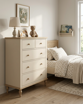 Children's bedroom with a chest of drawers, bed, and shelves.