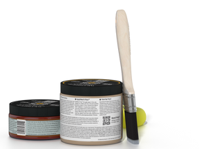 Two jars of a product with a brush on a white background