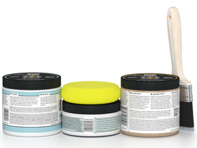 Three jars of paint with black lids and a paintbrush on a white background