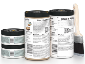 Three jars of paint with labels and a paintbrush on a white background