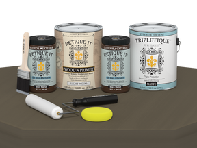 Collection of paint cans and painting tools on a brown surface