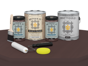 Collection of paint cans and painting tools on a brown surface