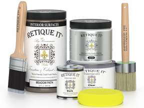Retique It furniture paint and wax products with brushes and a sponge on a white background