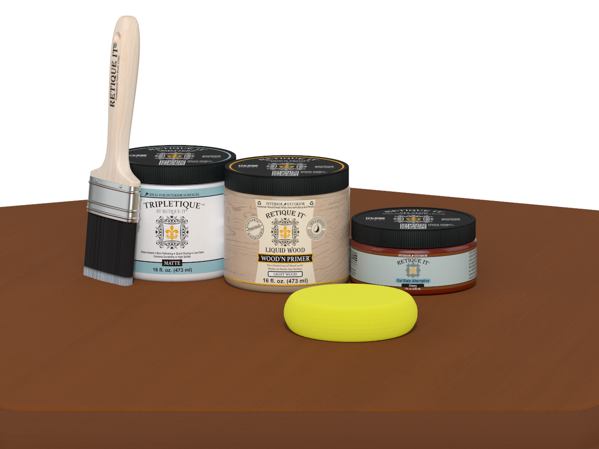 Collection of paint-related products including a brush, jars, and a sponge on a brown surface.