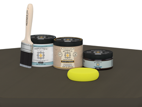 Collection of paint-related products including jars, a brush, and a sponge on a gray surface.