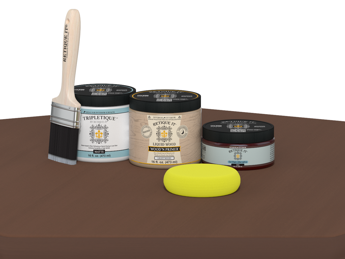 Collection of paint-related products including a brush, jars, and a sponge on a brown surface.